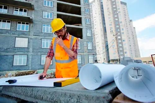Architect reviewing blueprints